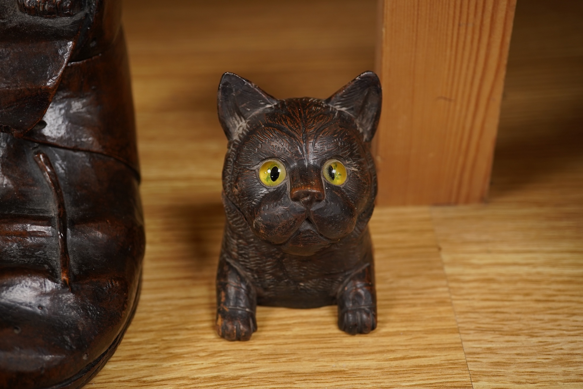 A Black Forest carving of a kitten in a boot inkwell and another car inkwell, tallest 15cm